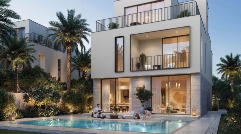 Villa moderne de trois étages à The Heights, avec de grandes fenêtres, des balcons et des éclairages extérieurs, entourée de palmiers et d'une végétation luxuriante. Un couple se détend au bord de la piscine, créant une atmosphère luxueuse et paisible au crépuscule.