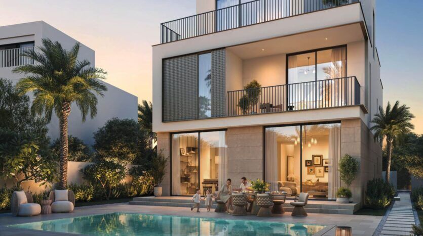 Maison moderne de deux étages à The Heights, avec de grandes baies vitrées, un balcon et des sièges extérieurs au bord d'une piscine. Des palmiers et de la verdure luxuriante entourent la zone tandis que les gens se détendent au bord de la piscine au coucher du soleil.