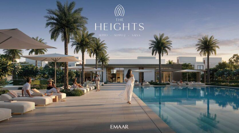 Une femme en robe blanche se promène au bord d'une piscine luxueuse à The Heights, entourée de chaises longues, de palmiers et de bâtiments modernes, avec des personnes se relaxant sous des parasols ; les logos "The Heights" et "EMAAR" apparaissent au-dessus.