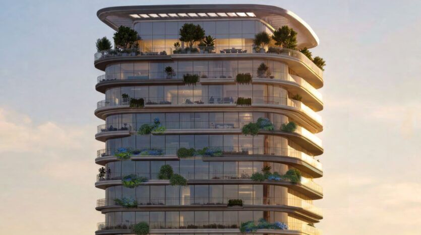 The Château is a modern high-rise building with curved glass balconies and adorned with lush vegetation and trees on each level, creating a garden-like appearance against a soft, golden sky.