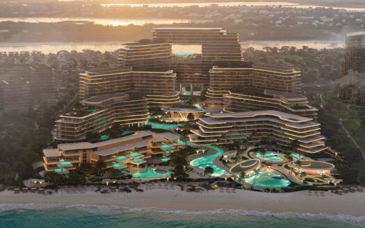 Vista aerea di Meriva, una località balneare di lusso con edifici moderni, grandi piscine e palme con vialetti sinuosi, sullo sfondo l'oceano al tramonto e una zona residenziale in lontananza.