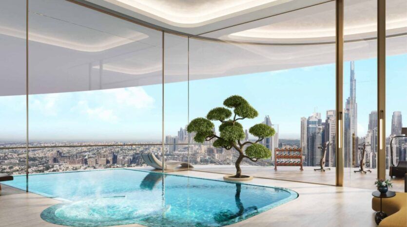 La luxueuse piscine intérieure des résidences Amali, agrémentée d'un bonsaï, donne sur l'horizon de la ville par des fenêtres allant du sol au plafond, avec des gratte-ciel modernes et un ciel bleu limpide.