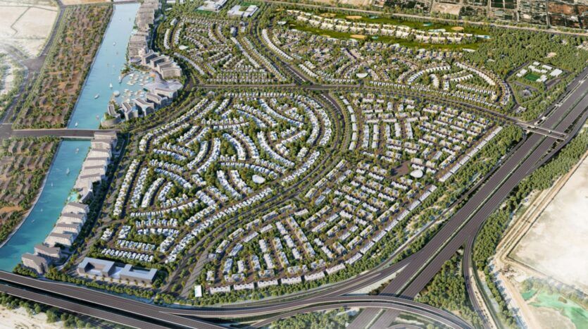 Vue aérienne de River Cove Residences, un grand quartier moderne avec des rues sinueuses, des groupes de maisons, des espaces verts luxuriants, un cours d'eau à gauche, et les principales autoroutes qui bordent la zone à droite et en bas.