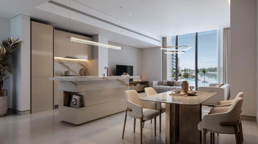 Cuisine et espace de vie modernes à la décoration minimaliste, surfaces en marbre, table à manger pour quatre personnes, grandes fenêtres, luminaires élégants et vue sur l'eau et les arbres : vivez une expérience raffinée dans les River Cove Residences.