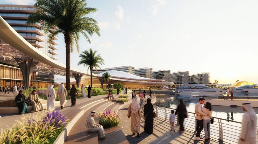 Des personnes portant des vêtements traditionnels et modernes se promènent et se détendent le long d'une promenade au bord de l'eau près de The Terraces by Sobha, avec des yachts, des palmiers et des bâtiments modernes en arrière-plan, sous un ciel ensoleillé.