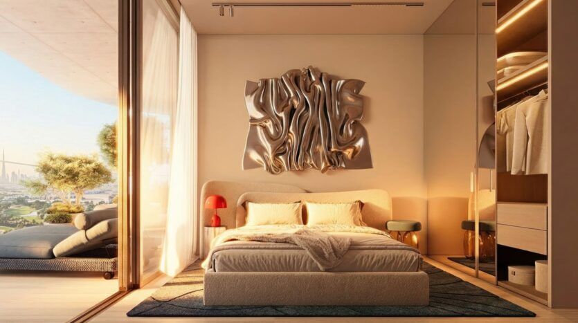 The modern bedroom in the Wow Tower features a king-size bed, an abstract metal wall art piece above the headboard, glass doors leading to a balcony with greenery, and a walk-in closet with warm lighting on the right.