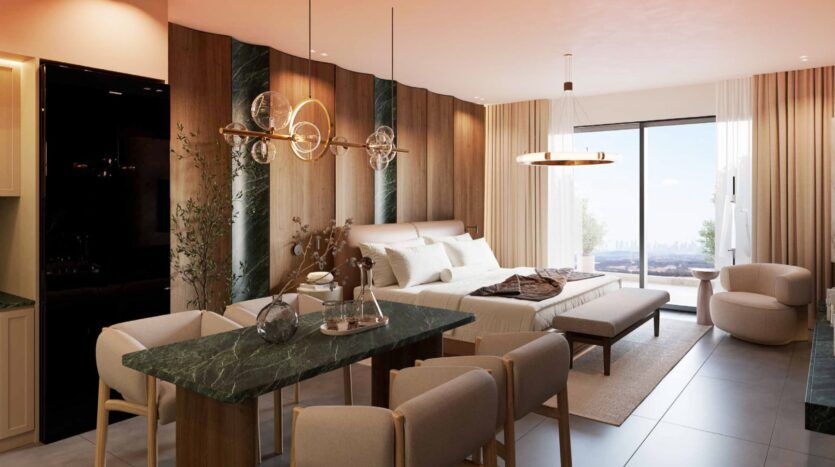 Une chambre à coucher et un salon modernes et ouverts, avec un mobilier élégant, une table à manger en marbre vert Calisi by Zoya, un lit confortable, des chaises aux tons neutres, de grandes fenêtres et la lumière naturelle qui remplit l'espace.