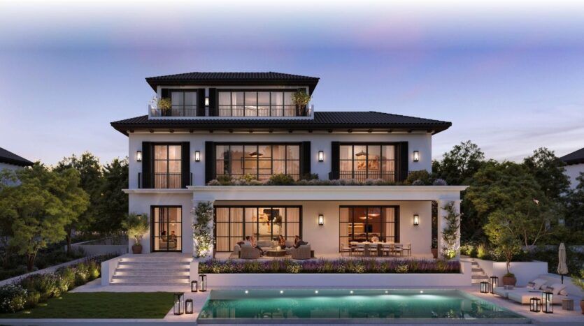 Maison moderne de trois étages avec de grandes fenêtres et des terrasses à Hudayriyat Golf Estates, entourée de verdure. L'arrière-cour comprend un patio spacieux avec des sièges, une salle à manger et une piscine, le tout éclairé par des lumières extérieures à la tombée de la nuit.