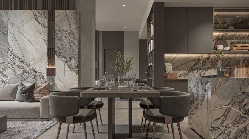 Salle à manger moderne avec une table pour six personnes, entourée de chaises rembourrées. L'espace sophistiqué présente des surfaces en marbre et un éclairage élégant, faisant écho au style raffiné d'Oxford Cove by Iman dans une cuisine minimaliste aux tons neutres.