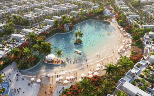 Vista aérea de un complejo de lujo con una gran piscina estilo laguna rodeada de exuberante vegetación tropical y numerosas villas blancas bajo un cielo soleado en el sur de Dubai.