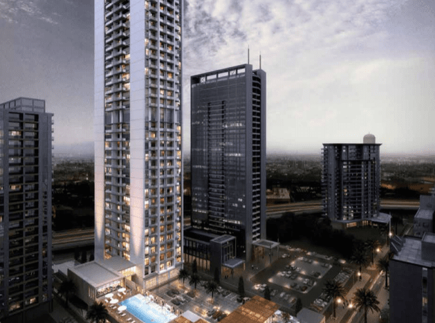 Représentation artistique d'un horizon urbain moderne au crépuscule, mettant en vedette un immeuble de grande hauteur avec une piscine éclairée sur le toit près du Studio One Dubai Marina et des bâtiments plus petits environnants.