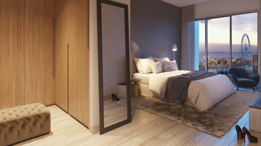 Un studio moderne au crépuscule dans la marina de Dubaï avec un grand lit, des baies vitrées donnant sur un paysage urbain avec une grande roue, une armoire en bois et un éclairage tamisé.
