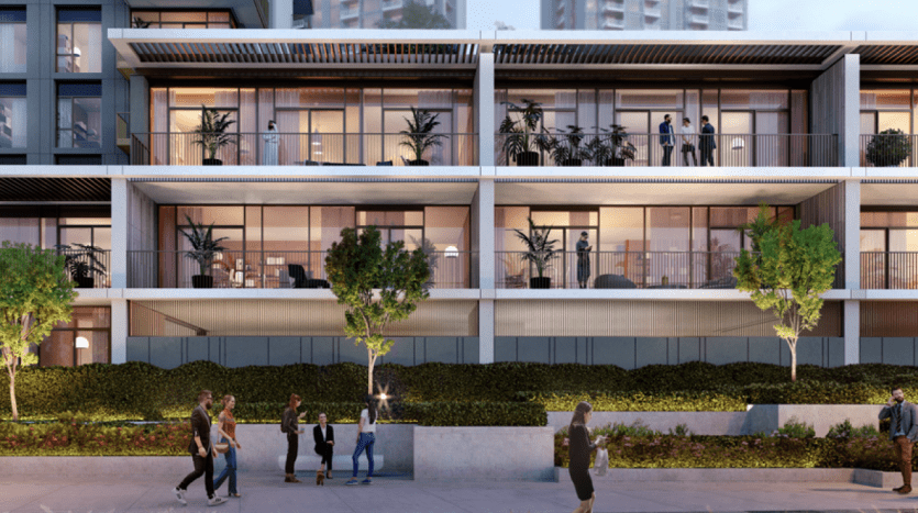 Immeuble d'appartements moderne avec balcons spacieux, occupé par divers résidents profitant de la soirée. Les gens marchent et interagissent dans la zone avant paysagée, éclairée par un éclairage doux, reflétant une opportunité d'investissement de premier ordre similaire à celles trouvées.