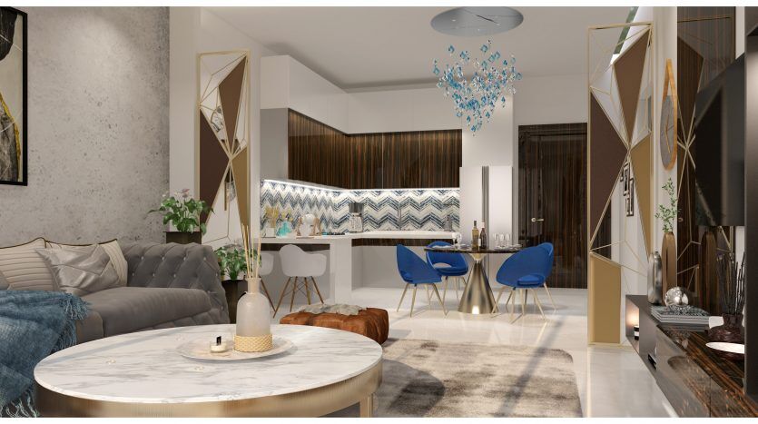 Un espace de vie moderne et décloisonné dans une villa de Dubaï avec une table basse en marbre, un canapé gris et des chaises de salle à manger bleues. Des accents géométriques dorés et en miroir sur les murs et la décoration rehaussent l'intérieur sophistiqué