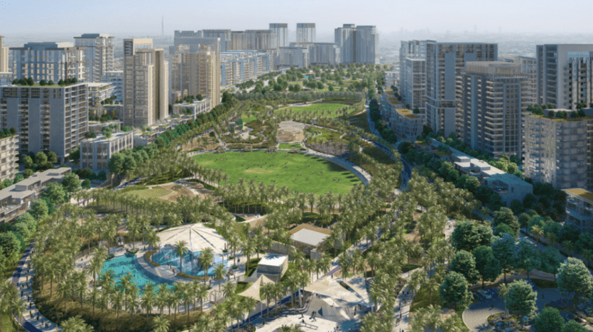 Vue aérienne d'un parc urbain moderne entouré d'immeubles résidentiels de grande hauteur, comprenant des espaces verts luxuriants, des sentiers pédestres, une grande pelouse centrale et un parc aquatique à proximité d'un appartement de Dubaï.