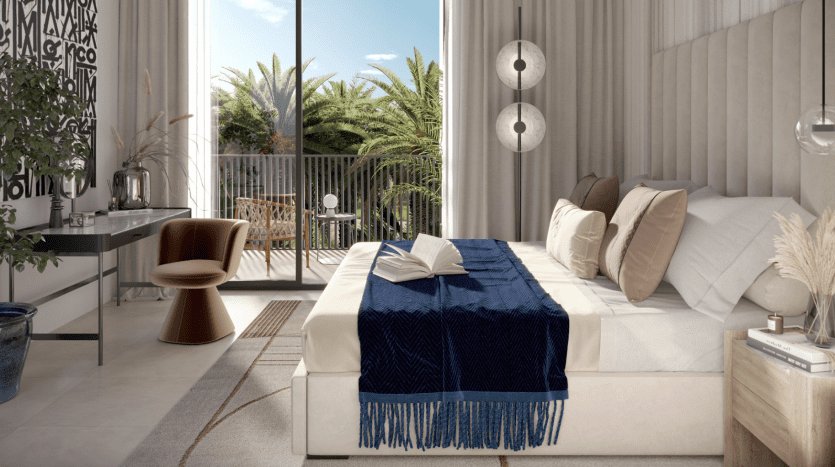 A modern room in a Dubai villa with a king-size bed adorned with a blue throw, a chair and desk near a window, round mirrors on the wall and a balcony with visible palm trees.
