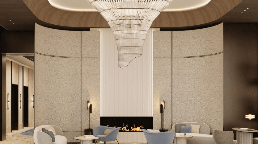 Hall d'entrée d'hôtel moderne au décor luxueux, doté d'un élégant lustre monté au plafond, d'une cheminée centrale, de sièges gris pâle et de panneaux muraux contemporains typiques d'un appartement haut de gamme de Dubaï.
