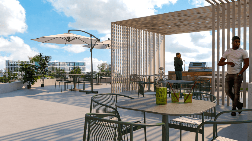 Toit-terrasse moderne doté de mobilier d'extérieur design, d'une pergola en bois et de plantes en pot. Deux personnes se détendent dans un endroit ensoleillé, avec en arrière-plan un paysage urbain animé de Dubaï.