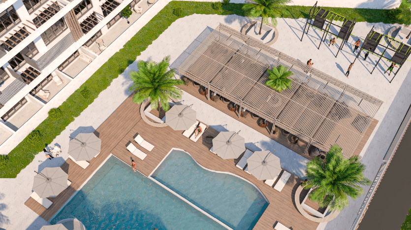 Vue aérienne d'une villa de luxe à Dubaï comprenant une piscine rectangulaire, des chaises longues sous des parasols, un pavillon, une zone herbeuse avec des palmiers et un jeu d'eau ludique, entourée de