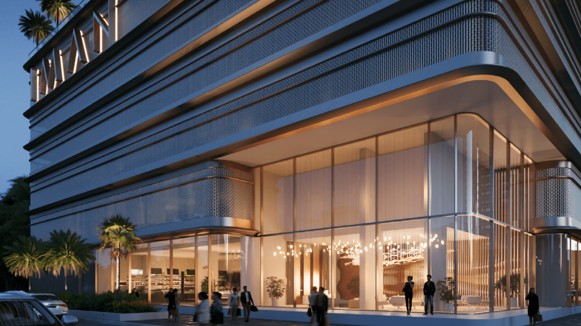 One Park Square est un bâtiment moderne doté de grandes baies vitrées et de motifs géométriques, magnifiquement éclairé de l'intérieur. Les gens passent devant tandis que des palmiers bordent son entrée, le tout sur fond de ciel sombre.