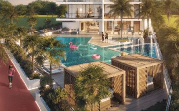 Espace piscine luxueux de style complexe entouré d'une verdure luxuriante, comprenant une grande piscine avec des flamants roses gonflables et une passerelle centrale. les gens profitent tranquillement de l’ambiance ensoleillée.