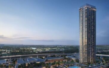 Une grande tour moderne, la Résidence Lyvia by Palace à Dubai Creek Harbour, se détache sur un ciel crépusculaire, entourée de structures basses, de verdure et d'un paysage urbain lointain avec des routes et des champs visibles.