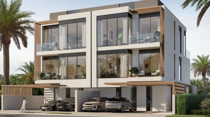 Duplex moderne de deux étages avec de grandes fenêtres en verre et des balcons, avec une cour avant paysagée, des voitures garées et une personne qui passe. Annonce idéale pour une agence immobilière Dubaï.